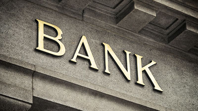 An old fashioned 'Bank' sign on a building exterior.