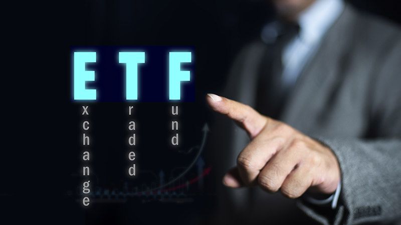 Businessman pointing at ETF (Exchange Traded Funds). Investment Opportunities in Mutual Funds and ETFs, Growing Wealth in the Financial Market.