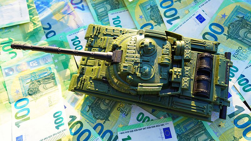 Tank on background of banknotes. Currency war. War costs, military spending. Making money from war. Money laundering on War. Military economy. Military tank and European banknotes. Weapons trade.