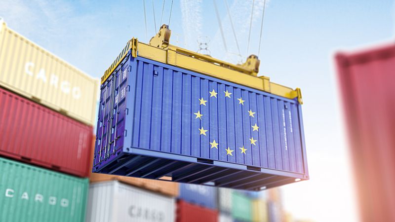 Cargo shipping container with EU European Union flag in a port harbor. Production, delivery, shipping and freight transportation of EU products concept. 3d illustration